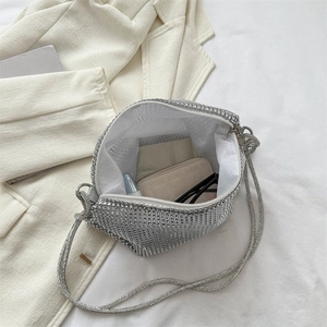 Silver rhinestone hobo bag showing capacity for wallet, lipstick and sunglasses