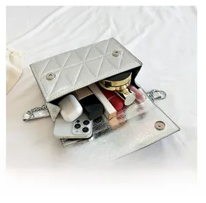 Internal view of silver quilted crossbody bag showing space for phone and cosmetics