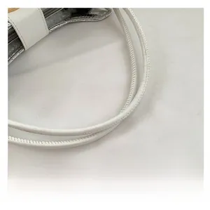 Close-up of white leather handle with precision stitching and silver fabric lining