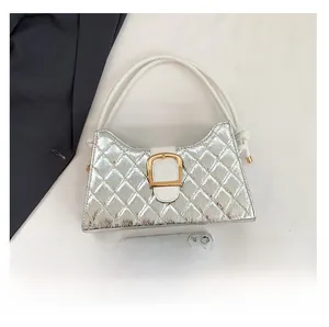 Silver quilted baguette bag next to a smartphone showing its actual compact size