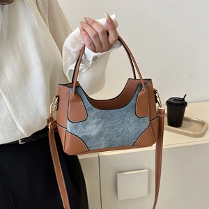 Minimalist colorblock shoulder bag with brown leather and blue denim texture panels