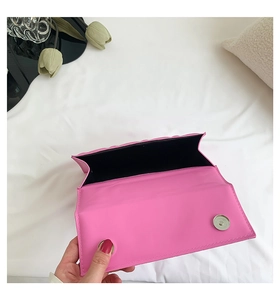 Détail du petit sac bandoulière matelassé rose vif avec fermeture magnétique et doublure noire