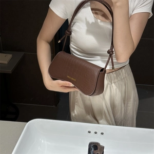 Brown crocodile texture crossbody bag with gold lettering and knot strap detail