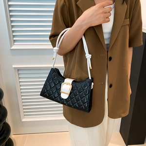 Quilted black baguette bag with white rope strap and large buckle shown on a model