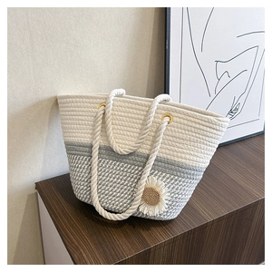 Handwoven cotton tote bag in beige and gray with daisy floral accent and rope handles