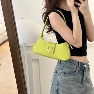 Neon green half-moon underarm bag with gold ring buckle shown in a mirror selfie