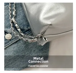 Close-up of woven silver metal and leather chain strap attached to the silver tote bag