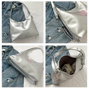 Close-up of liquid silver hobo bag featuring pink butterfly embroidery and chain strap