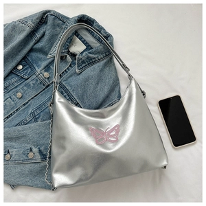 Detail shot of silver metallic hobo bag with pink butterfly embroidery and chain strap