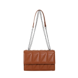 Caramel brown quilted chain flap crossbody bag with geometric stitching on white background