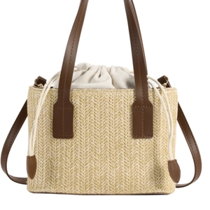 Summer straw tote bag with brown leather straps and drawstring inner pocket