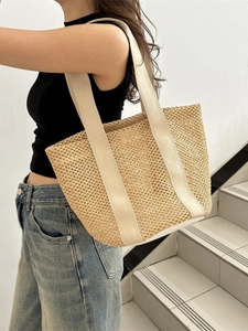 Straw hollow woven tote bag with canvas straps for summer beach or casual vacation use