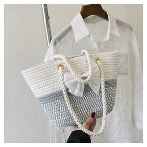 Woven tote bag in white and grey contrast with oversized organza bow and rope handle