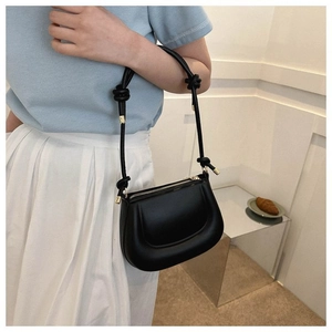 Vue latérale du sac hobo en cuir noir avec bandoulière nouée et détails métalliques