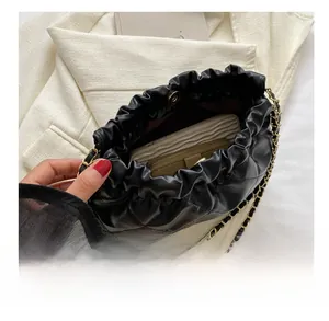 Interior view of black quilted leather tote bag showing spacious capacity and chain strap