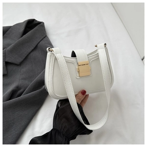 Close-up of white PU leather underarm bag featuring a metallic gold rectangular buckle