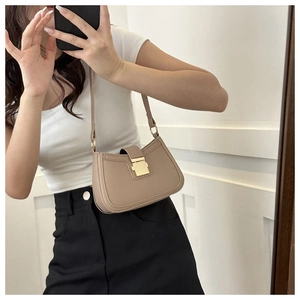 Mirror selfie showing the fit of an apricot PU leather shoulder bag with a gold buckle