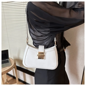 Close-up of white PU leather underarm bag featuring a prominent gold rectangular clasp