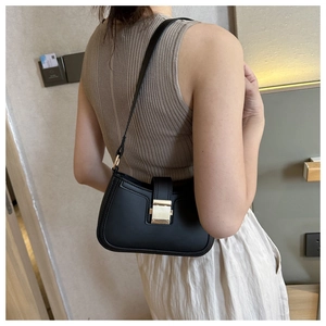 Detail shot of a black PU underarm bag featuring a prominent square gold metal buckle