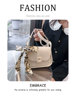 Detail of beige leather crossbody bag with square lock and vintage print silk scarf