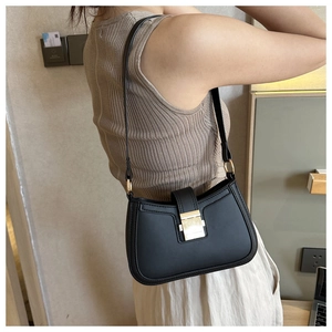 Chic black PU leather half-moon underarm bag with gold buckle detail on model