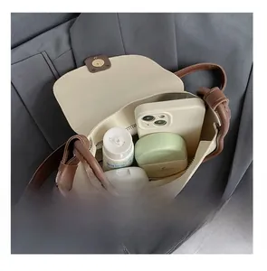 Interior view showing the storage capacity of the cream crossbody bag with silk scarf