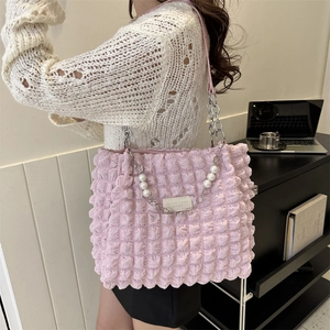 Pink popcorn texture tote bag with pearl chain strap and minimalist logo patch