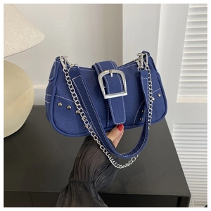 Close-up of denim shoulder bag with white contrast stitching and silver metal buckle