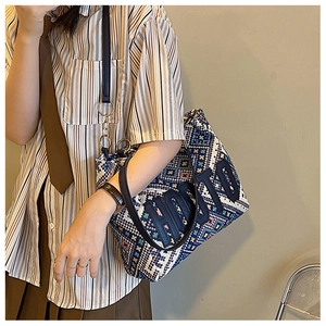 Close-up of retro ethnic tote bag showing jacquard texture and HOTO letter patch details