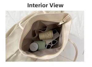 Detail of minimalist crocodile embossed tote bag interior showing large storage capacity
