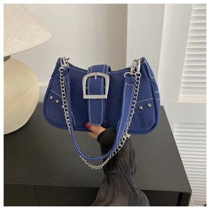 Detailed view of deep blue canvas bag with silver square buckle and chunky chain strap