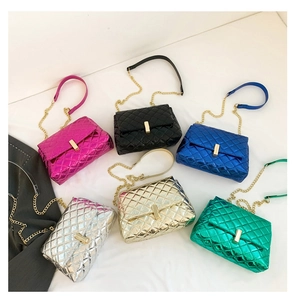 Detailed view of quilted crossbody bags in six vibrant metallic colors with gold clasps