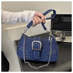 Detailed view of deep blue canvas underarm bag with silver chain and metal buckle