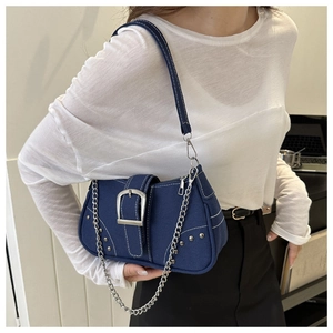 Detail of dark blue canvas shoulder bag with white contrast stitching and silver buckle