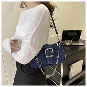 Blue canvas underarm bag featuring silver metal buckle, studs, and chain strap details