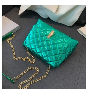 Detail of metallic lime green quilted crossbody bag with gold chain strap and lock