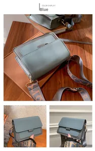 Detail of blue and grey crossbody bag with abstract patterned wide shoulder strap