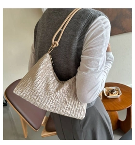 Détail du sac cabas plissé couleur champagne avec texture de soie et bandoulière à nœud