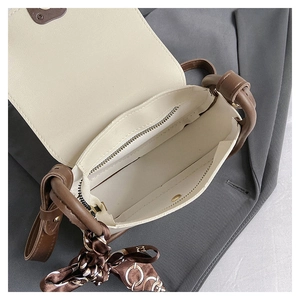 Detail view of small square bag interior with main compartment and zipped pocket