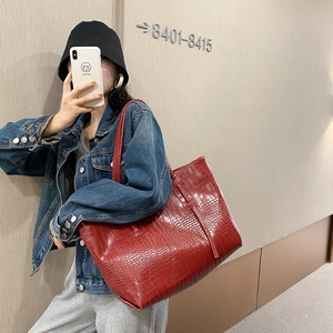 Large red crocodile pattern tote bag with glossy finish and long shoulder straps