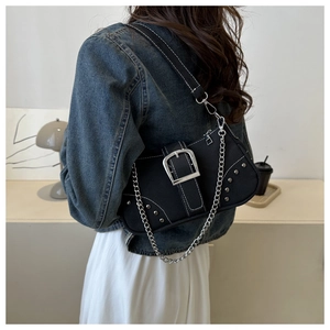 Detail of black denim hobo bag with silver buckle, rivets and chic metal chain strap