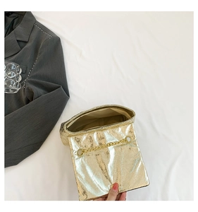 Detail view of the metallic gold quilted bag interior and gold chain strap