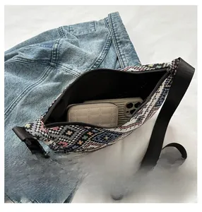 Inside view of ethnic woven crossbody bag showing capacity for phone and wallet