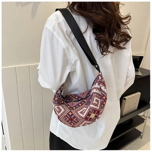 Detail of vintage geometric moon bag featuring ethnic patterns and nylon shoulder strap