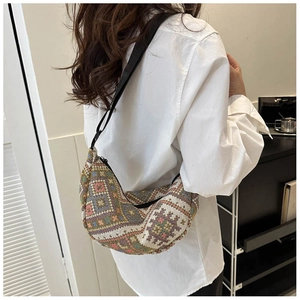 Detail of bohemian geometric pattern and adjustable strap on the crescent sling bag