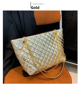 Detailed close-up of gold quilted tote bag featuring metallic texture and chain strap