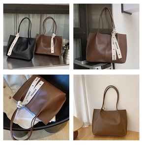 Detail view of large tote bags with decorative ribbon straps in black and brown colors