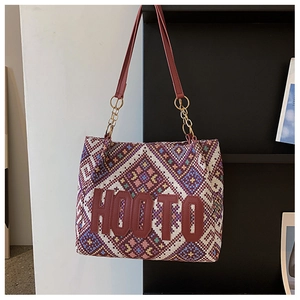 Detail of ethnic geometric tote featuring HOOTO leather patch and wine red strap