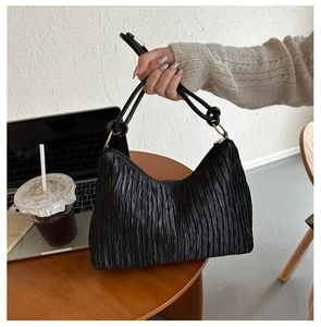 Détail du sac cabas plissé noir avec finition métallique et poignée nouée
