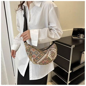 Detail of bohemian woven chest bag featuring colorful geometric patterns and black strap